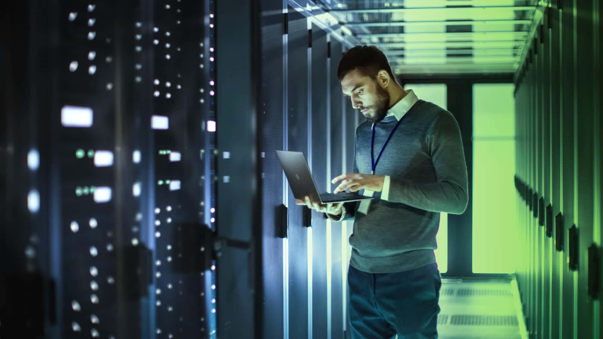 man on laptop at database server